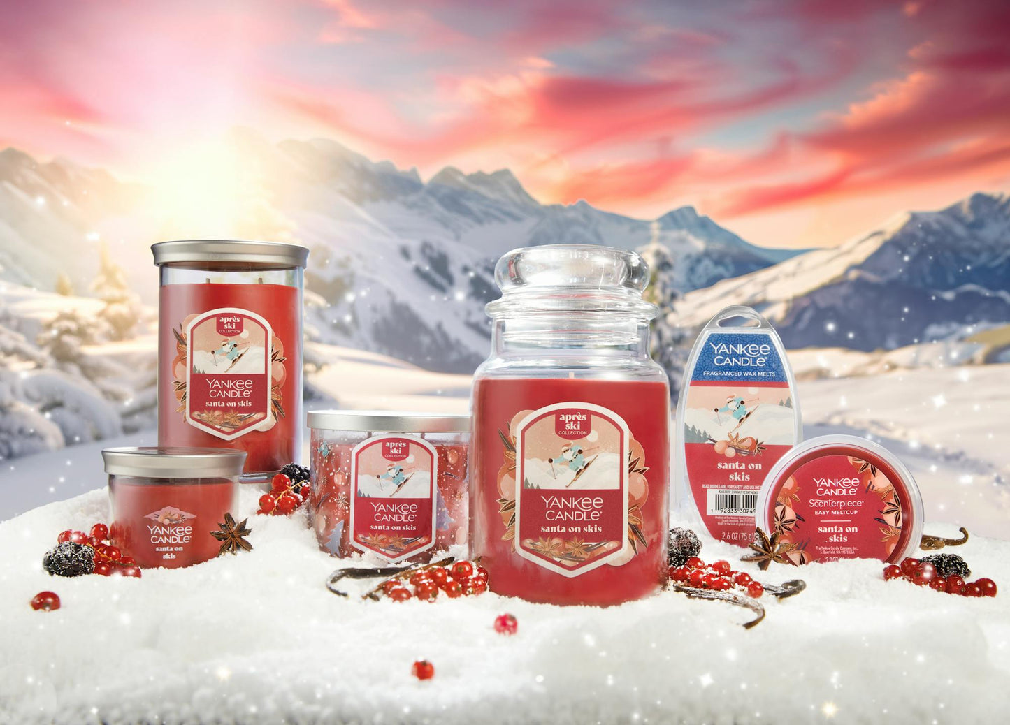 Apres Ski Collection Santa on Skis Signature Small Tumbler Candle, Santa on Skis Signature Large Tumbler Candle, Santa on Skis 3-Wick Candle, Santa on Skis Original Large Jar Candle, Santa on Skis Wax Melts 6-Pack, and Santa on Skis Scenterpiece Easy MeltCup in snow surrounded by berries, spices, and mountains