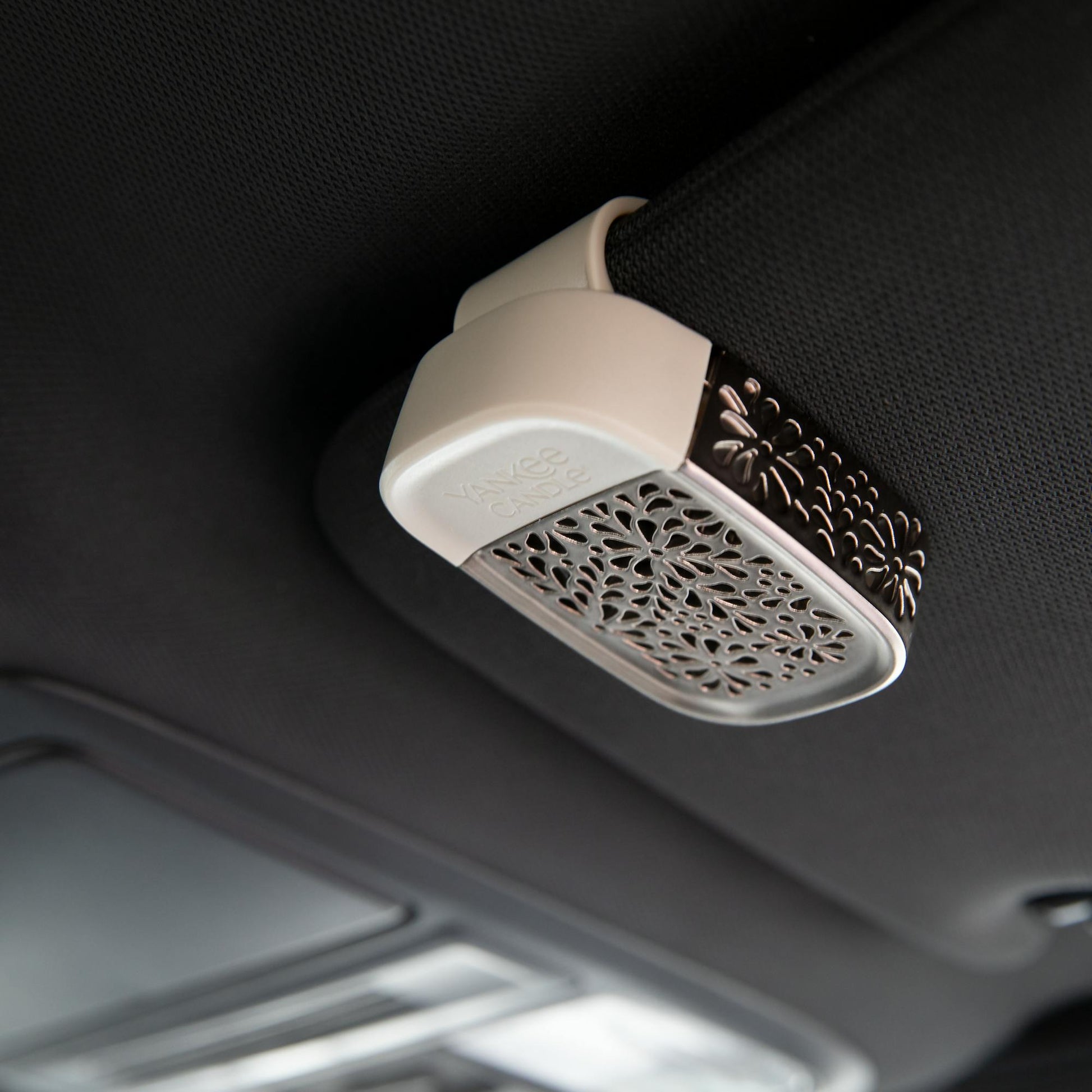 sidekick visor clip in nickel leaf pattern attached to car visor
