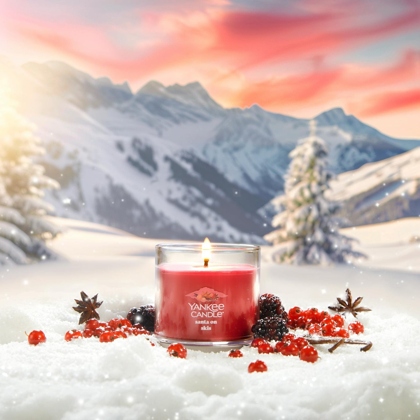 Apres Ski Collection Santa on Skis Signature Small Tumbler Candle in snow surrounded by berries, spices, and mountains