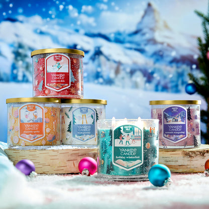 five apres ski collection three wick candles in snowy scene with birch slices and ornaments