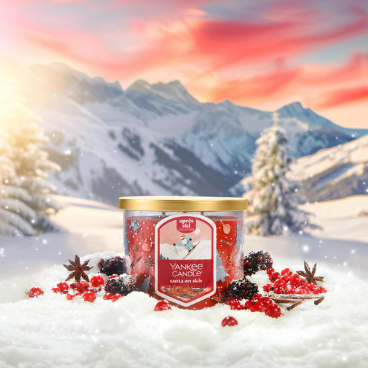Apres Ski Collection Santa on Skis 3-Wick Candle in snow surrounded by berries and mountains