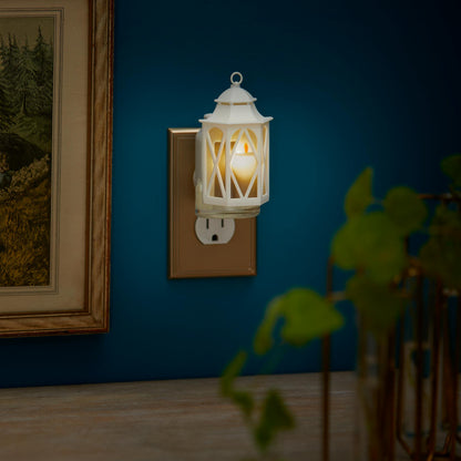 Spring Lantern ScentPlug Diffuser with a light plugged into a wall next to a photo in a frame