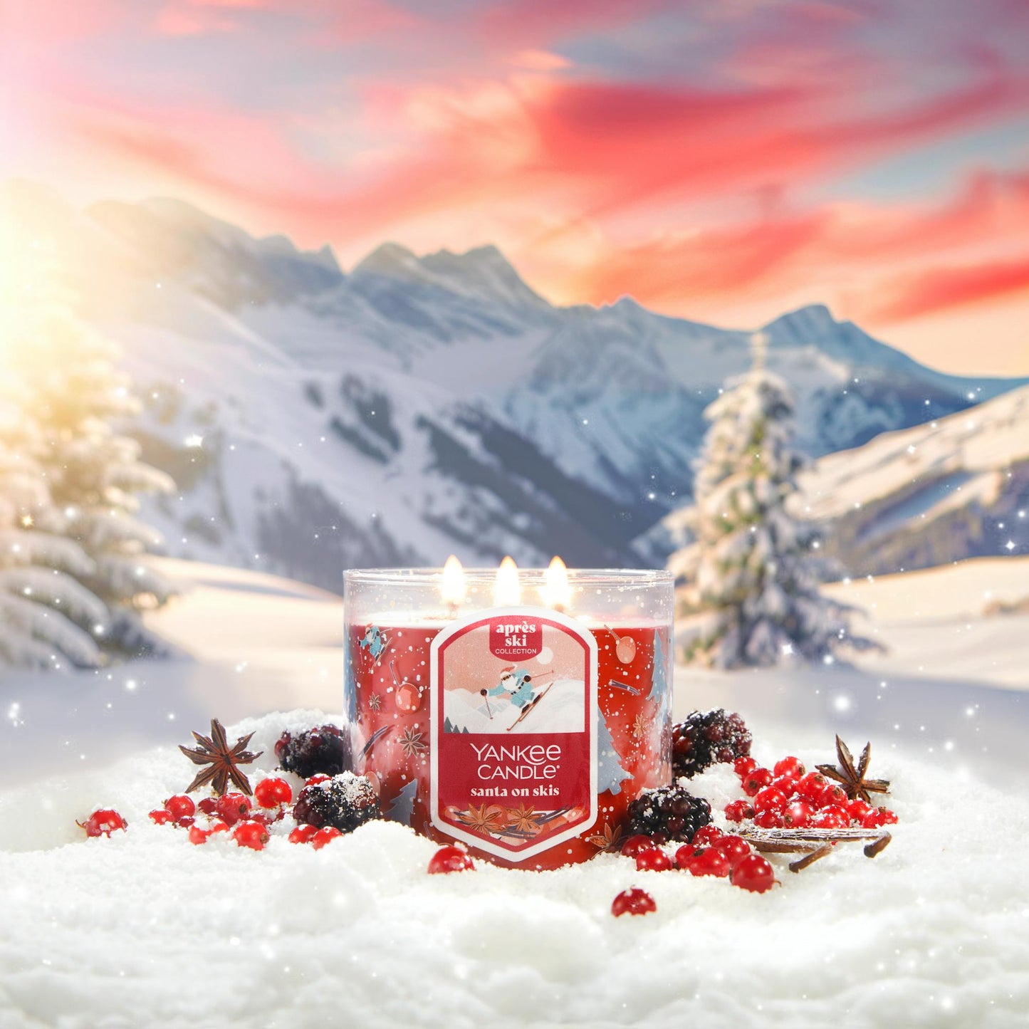 Apres Ski Collection Santa on Skis 3-Wick Candle in snow surrounded by berries, spices, and mountains
