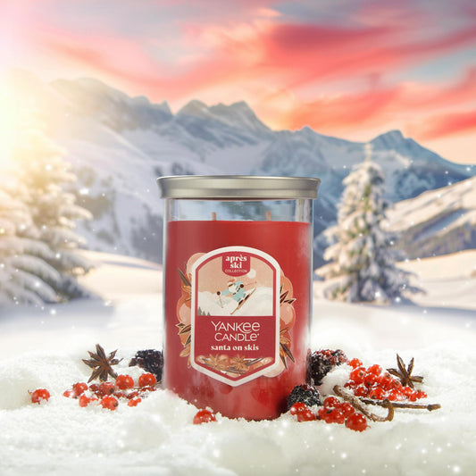 Apres Ski Collection Santa on Skis Signature Large Tumbler Candle in snow surrounded by berries, spices, and mountains